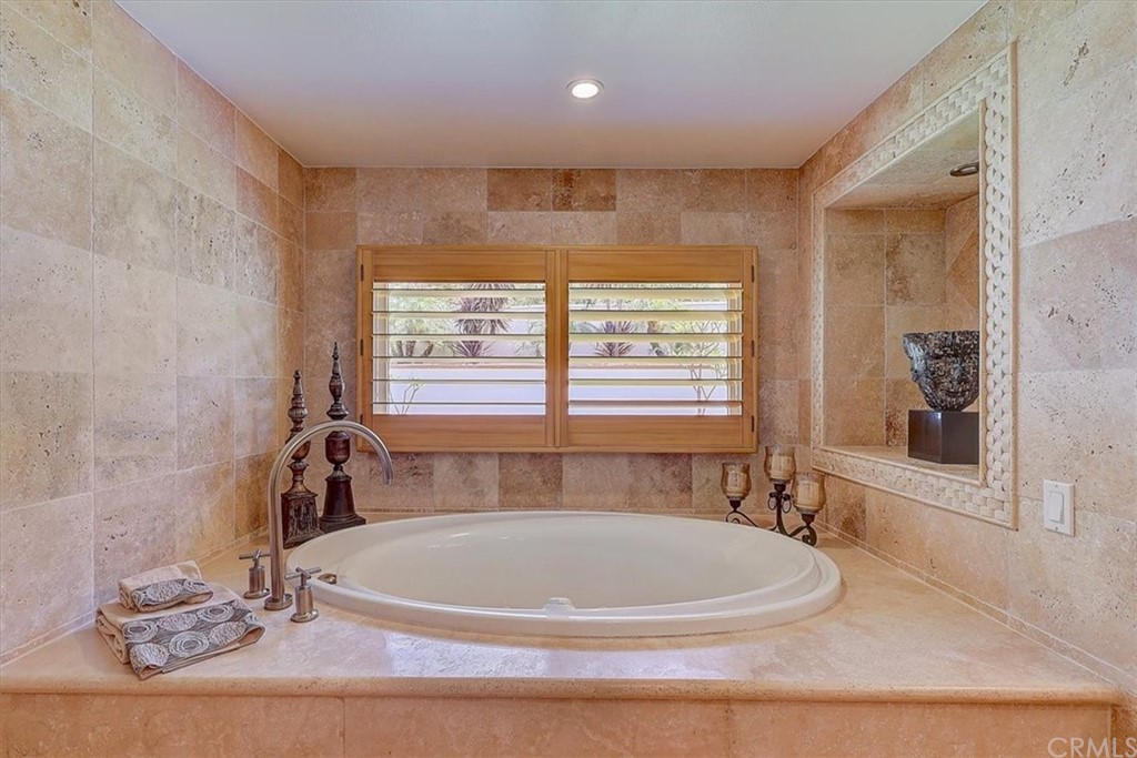 12392 Ranchview Drive Santa Ana, CA 92705 - Photo 40 of 72 a white bath tub sitting in a bathroom next to a window