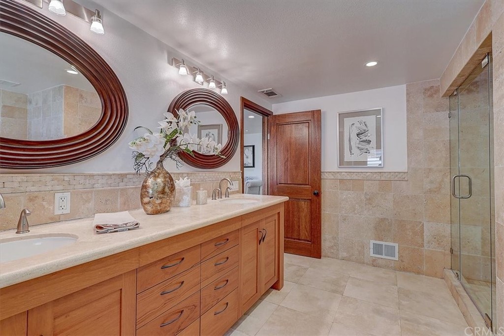 12392 Ranchview Drive Santa Ana, CA 92705 - Photo 41 of 72 a bathroom with a granite countertop double vanity sink and a mirror