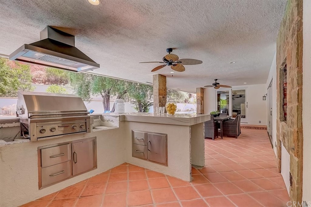 12392 Ranchview Drive Santa Ana, CA 92705 - Photo 57 of 72 a kitchen with a stove a sink and a refrigerator