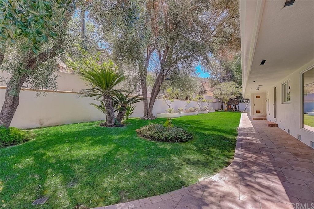 12392 Ranchview Drive Santa Ana, CA 92705 - Photo 65 of 72 a view of a yard with plants and a large tree