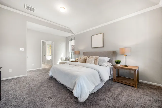 a large bed sitting in a bedroom and lamp