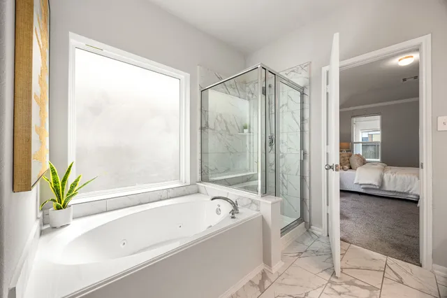 a bathroom with a bathtub and a shower