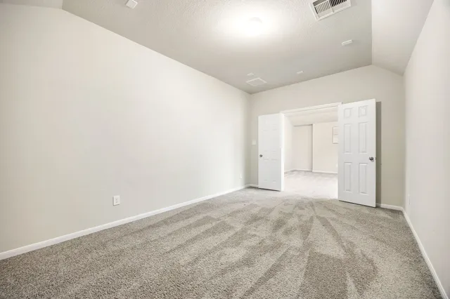 a bedroom with bed and a window