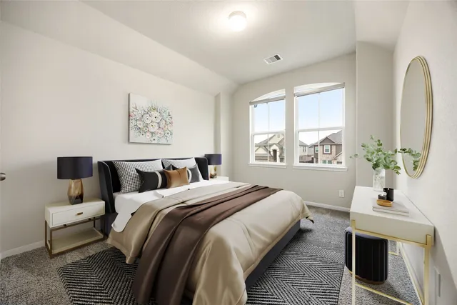 a bedroom with bed and a potted plant