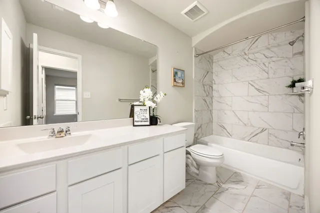 a bedroom with a bed and a couch