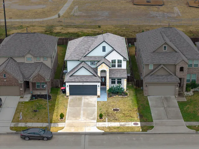 an aerial view of residential houses with outdoor space