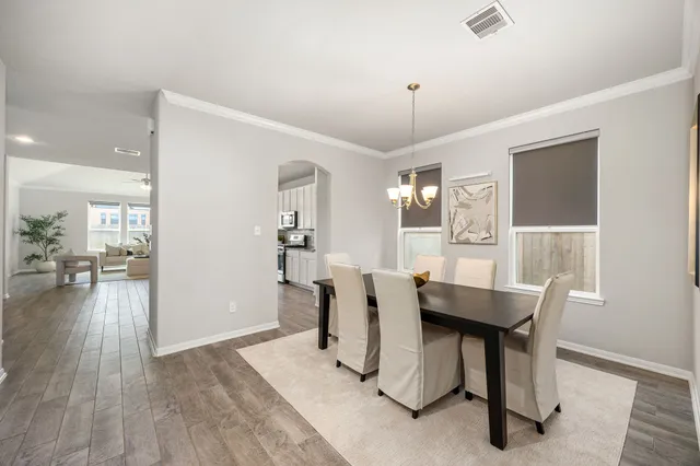 a view of a dining room with furniture and wooden floor
