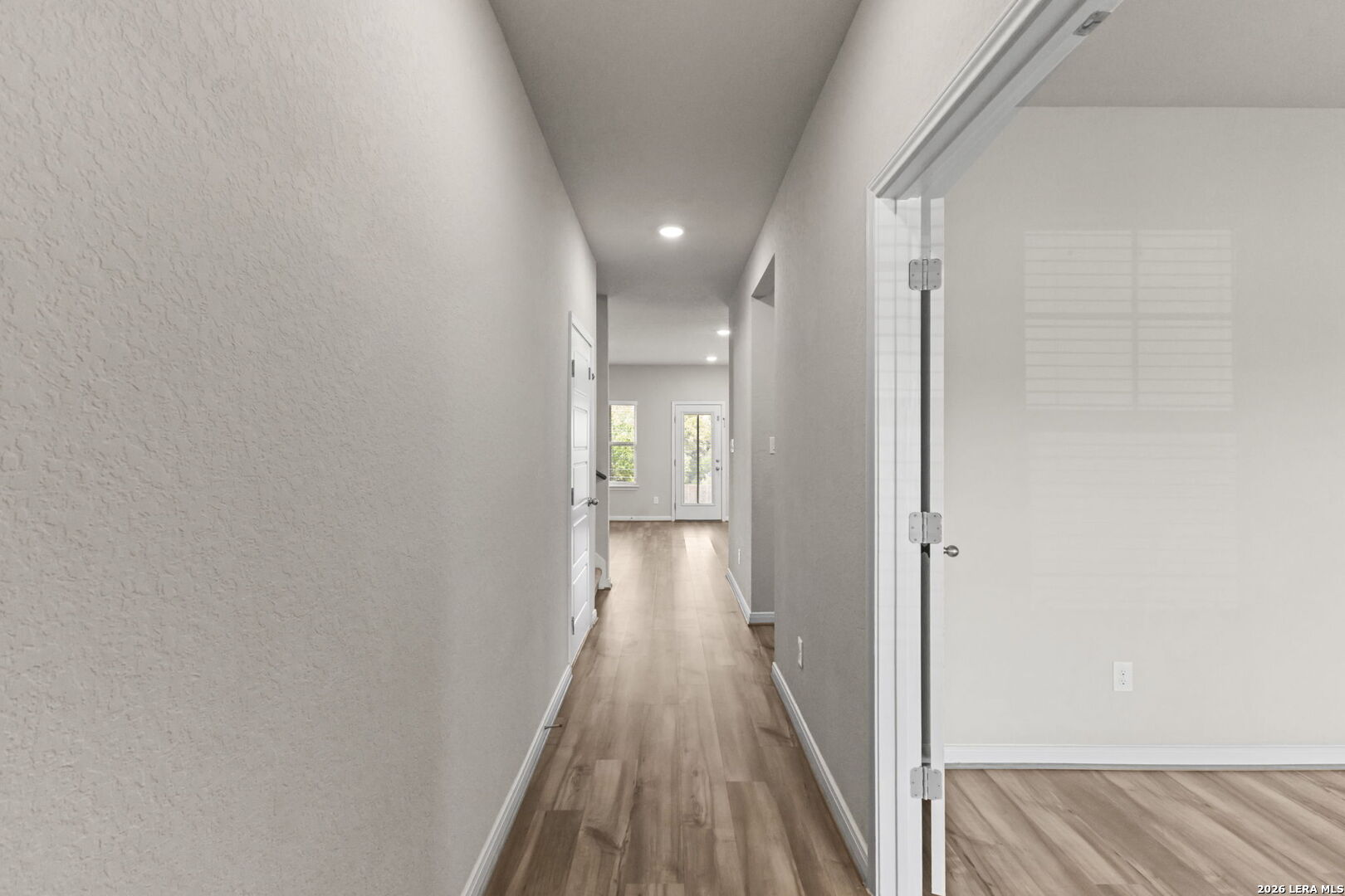 12221 Icon Ridge San Antonio, TX 78253 - Photo 15 of 46 a view of a hallway with wooden floor