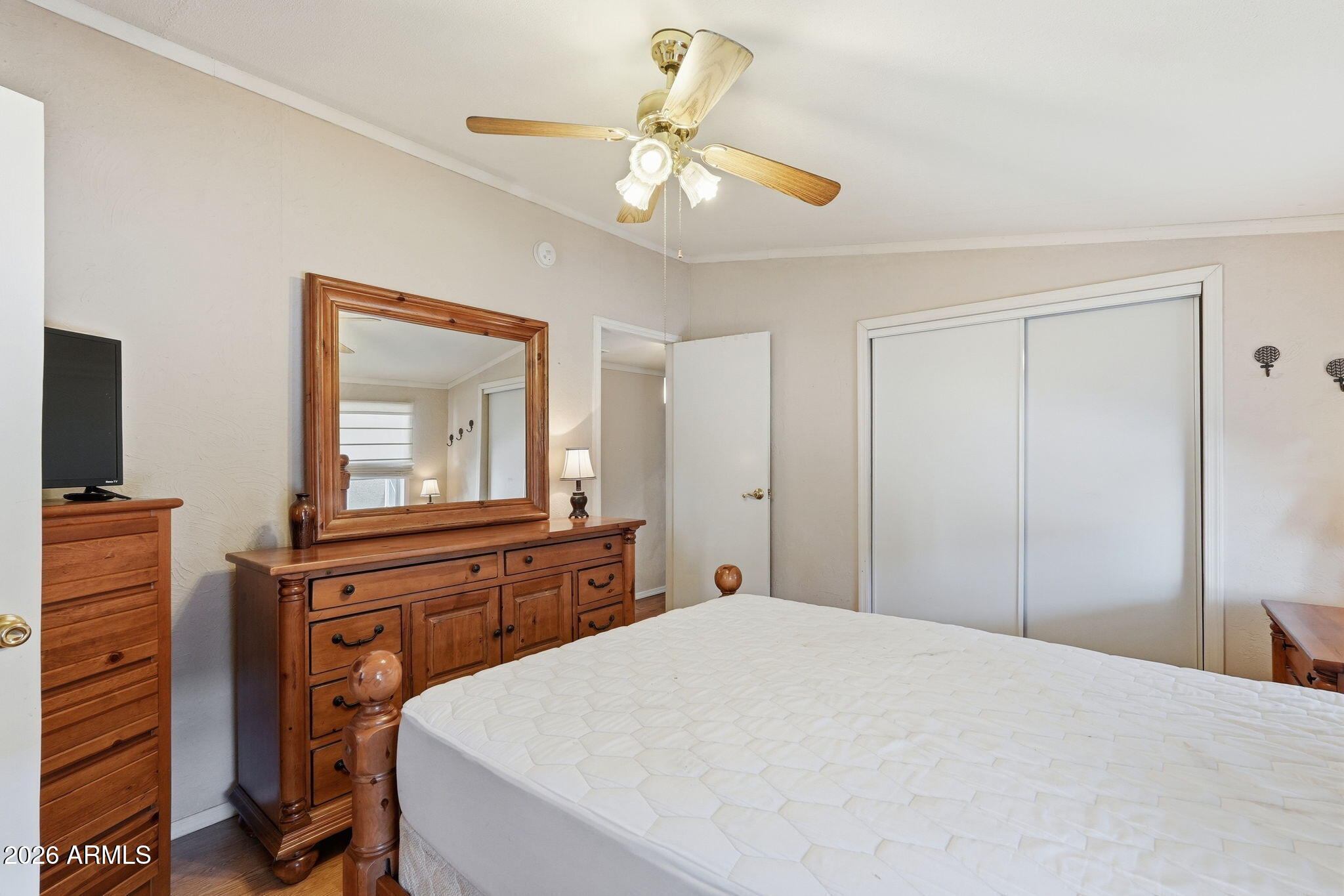 53 North Mountain Road, Unit 38 Apache Junction, AZ 85120 - Photo 19 of 35 a bedroom with a bed and a chandelier