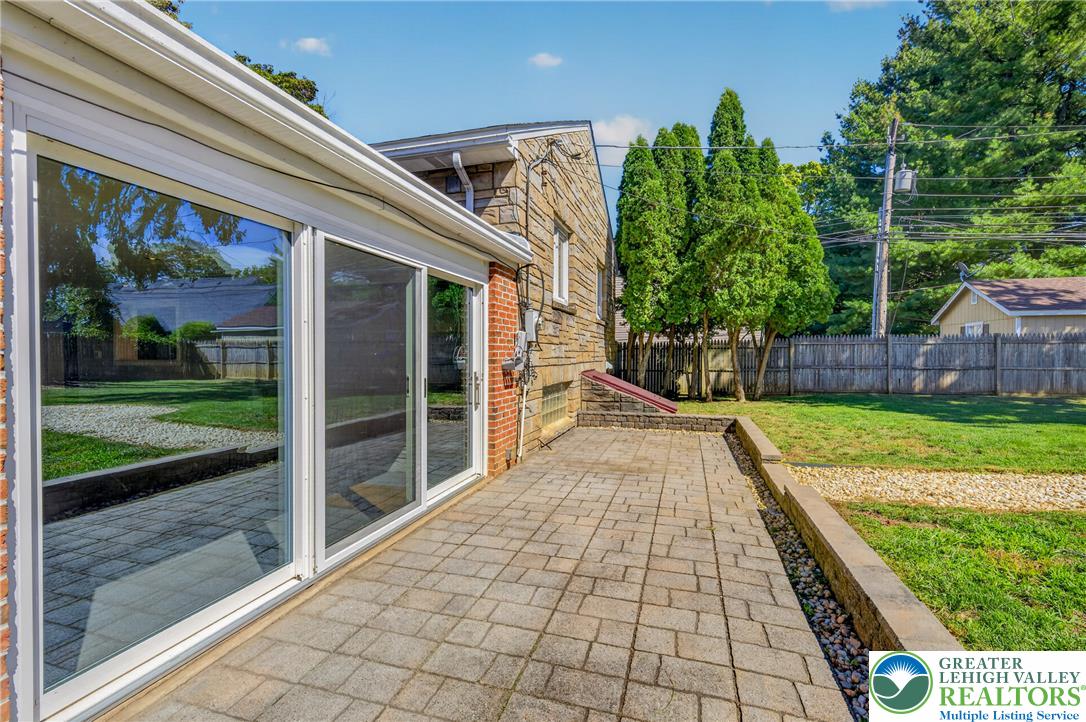 1814 Ruth Street Allentown, PA 18104 - Photo 47 of 54 A spacious brick patio borders the lawn alongside sliding glass doors and a level yard.