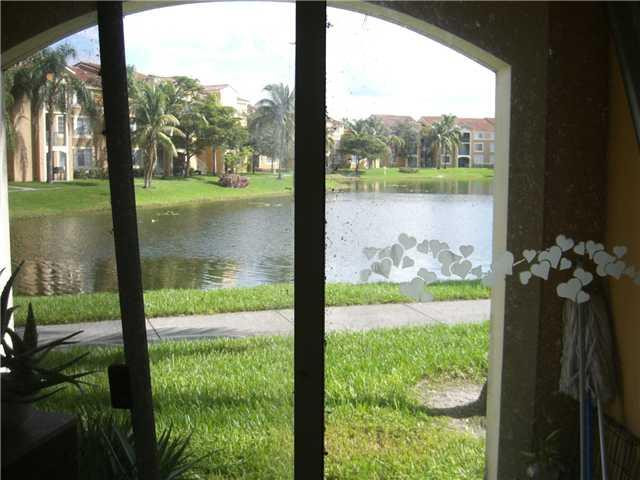 2123 Renaissance Boulevard, Unit 102 Miramar, FL 33025 - Photo 3 of 4 a view of lake from a porch