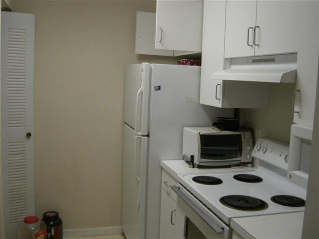 2123 Renaissance Boulevard, Unit 102 Miramar, FL 33025 - Photo 4 of 4 a kitchen with a refrigerator and a stove top oven