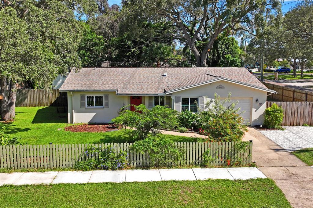 a front view of a house with a garden