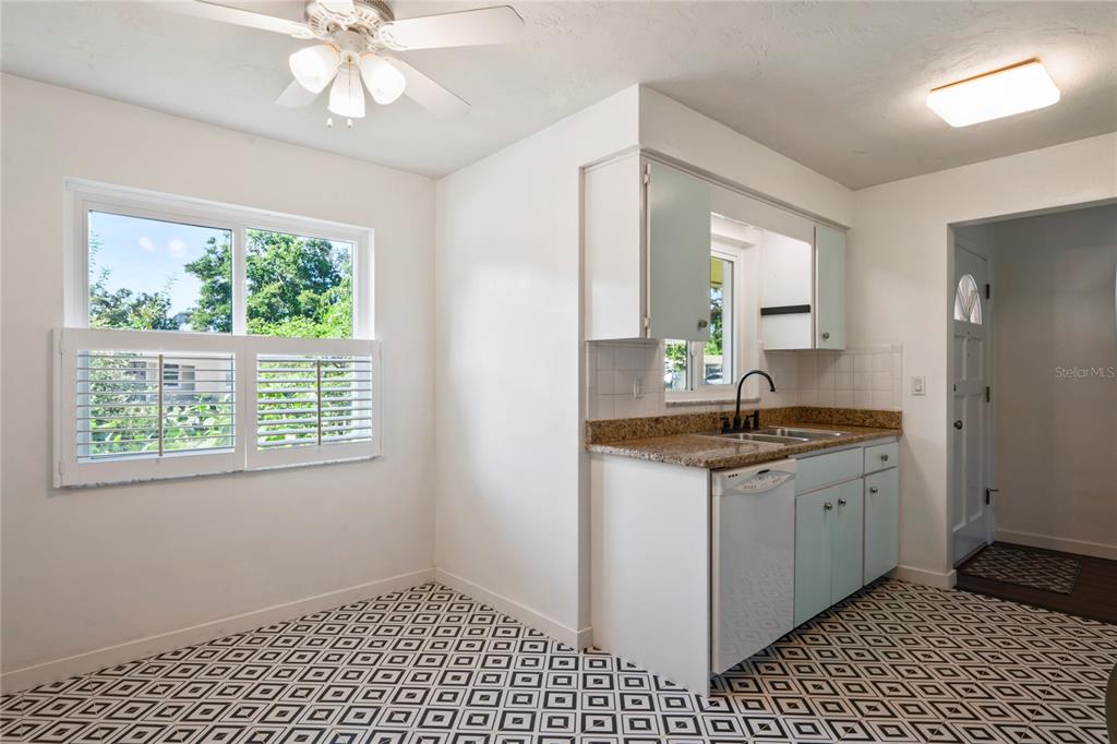 1282 Palm Street Clearwater, FL 33755 - Photo 11 of 55 a kitchen with a sink a window and cabinets