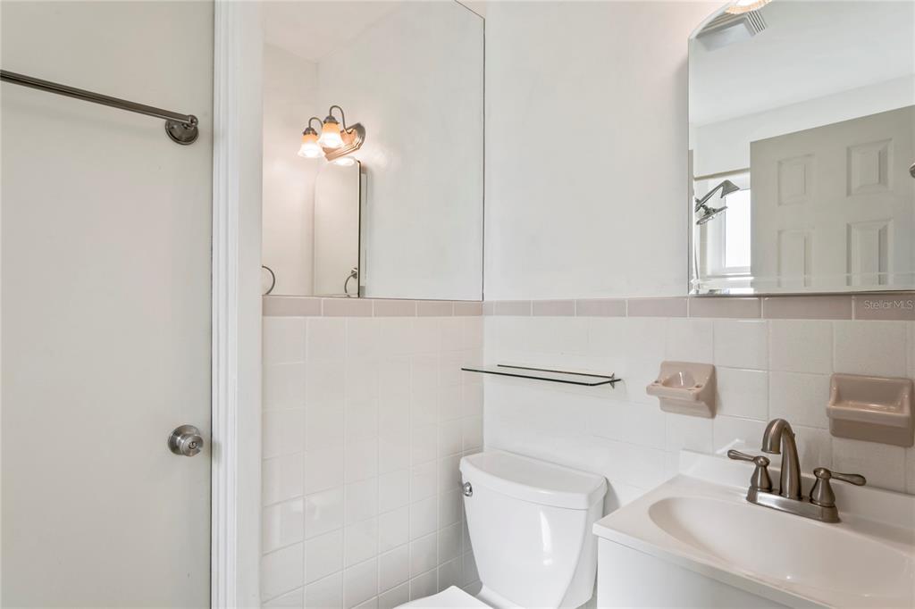 1282 Palm Street Clearwater, FL 33755 - Photo 19 of 55 a bathroom with a toilet sink and mirror