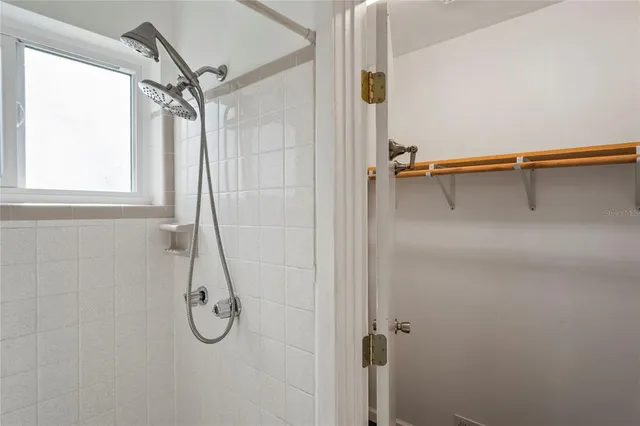 a bathroom with a shower and a window