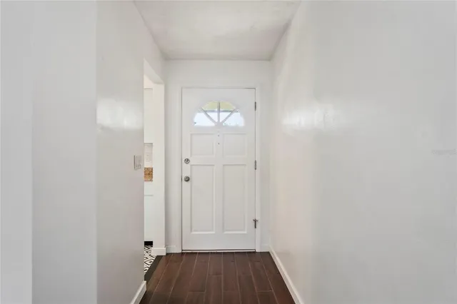 a view of an entryway with wooden floor