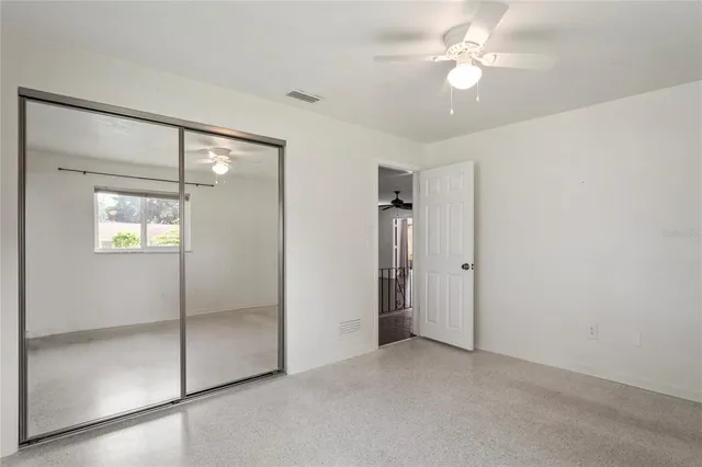 a view of an empty room with a fan