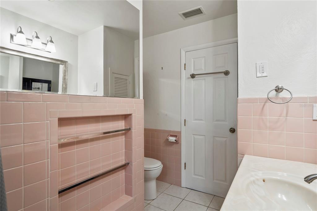 1282 Palm Street Clearwater, FL 33755 - Photo 25 of 55 a bathroom with a granite countertop sink a toilet and shower