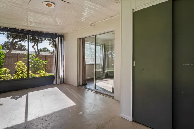 a view of a house with backyard and a tree