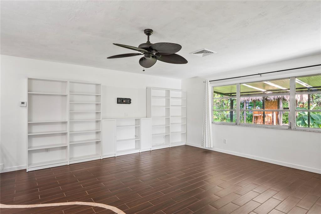1282 Palm Street Clearwater, FL 33755 - Photo 4 of 55 a view of an empty room with a window and wooden floor