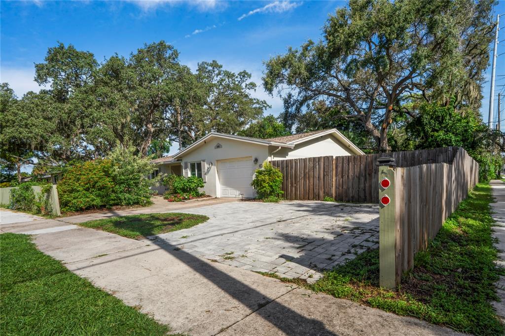 1282 Palm Street Clearwater, FL 33755 - Photo 44 of 55 a front view of a house with a yard and trees