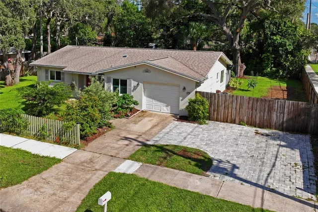an aerial view of a house with yard swimming pool and outdoor seating