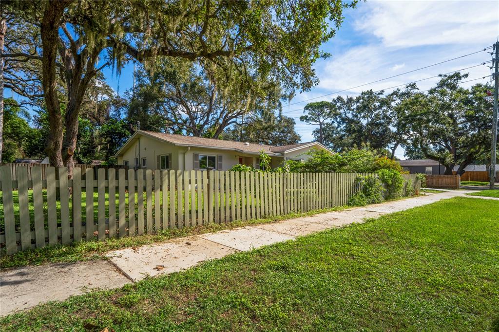 1282 Palm Street Clearwater, FL 33755 - Photo 49 of 55 a view of a house with a small yard and a large trees