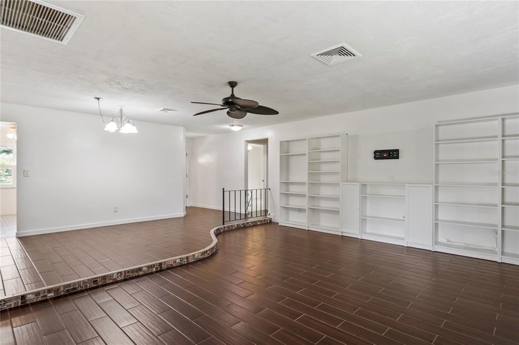 1282 Palm Street Clearwater, FL 33755 - Photo 5 of 55 an empty room with wooden floor and windows