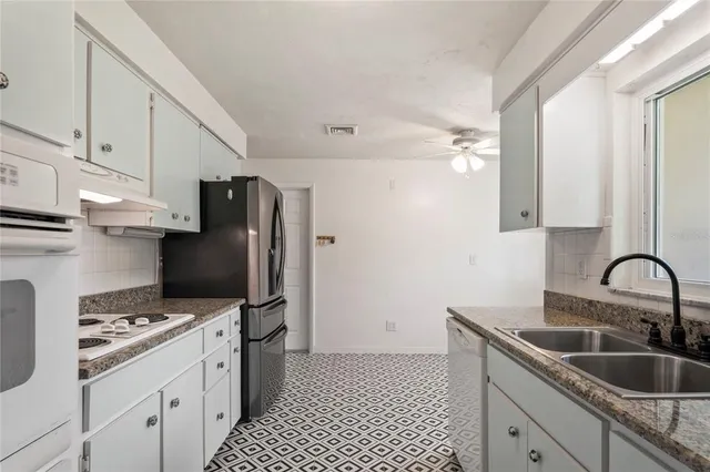 a kitchen with a sink cabinets and appliances
