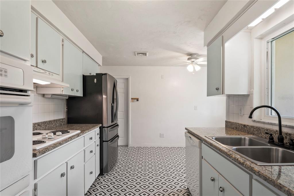 1282 Palm Street Clearwater, FL 33755 - Photo 7 of 55 a kitchen with a sink cabinets and appliances