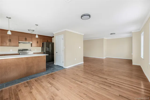 a view of kitchen with wooden floor and electronic appliances