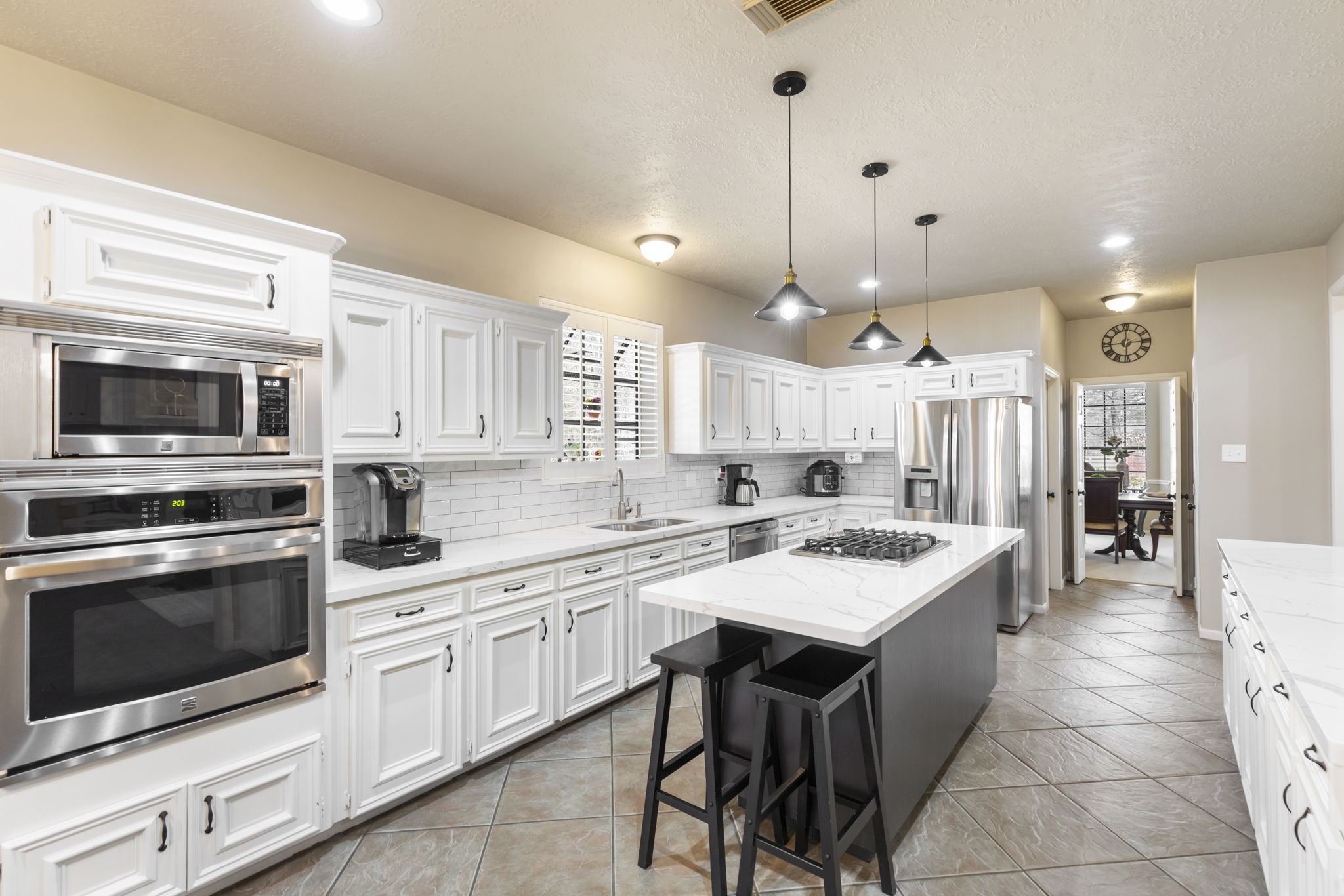 39327 Lago Drive Magnolia, TX 77354 - Photo 8 of 39 The island kitchen is the heart of the home, where sleek countertops gleam under soft pendant lighting, and the aroma of freshly brewed coffee or a simmering meal fills the air. Spacious and inviting, it’s designed for everything from casual breakfasts to lively gatherings, with plenty of room for loved ones to gather around, share stories, and create lasting memories.