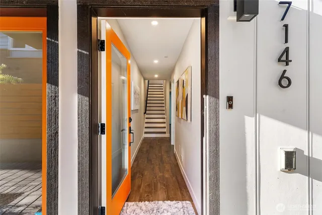 a view of a hallway with wooden floor and glass door