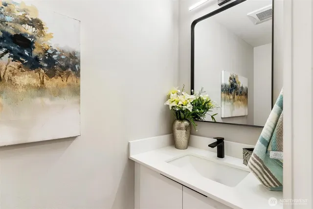 a sink with a cabinets and potted plant on it