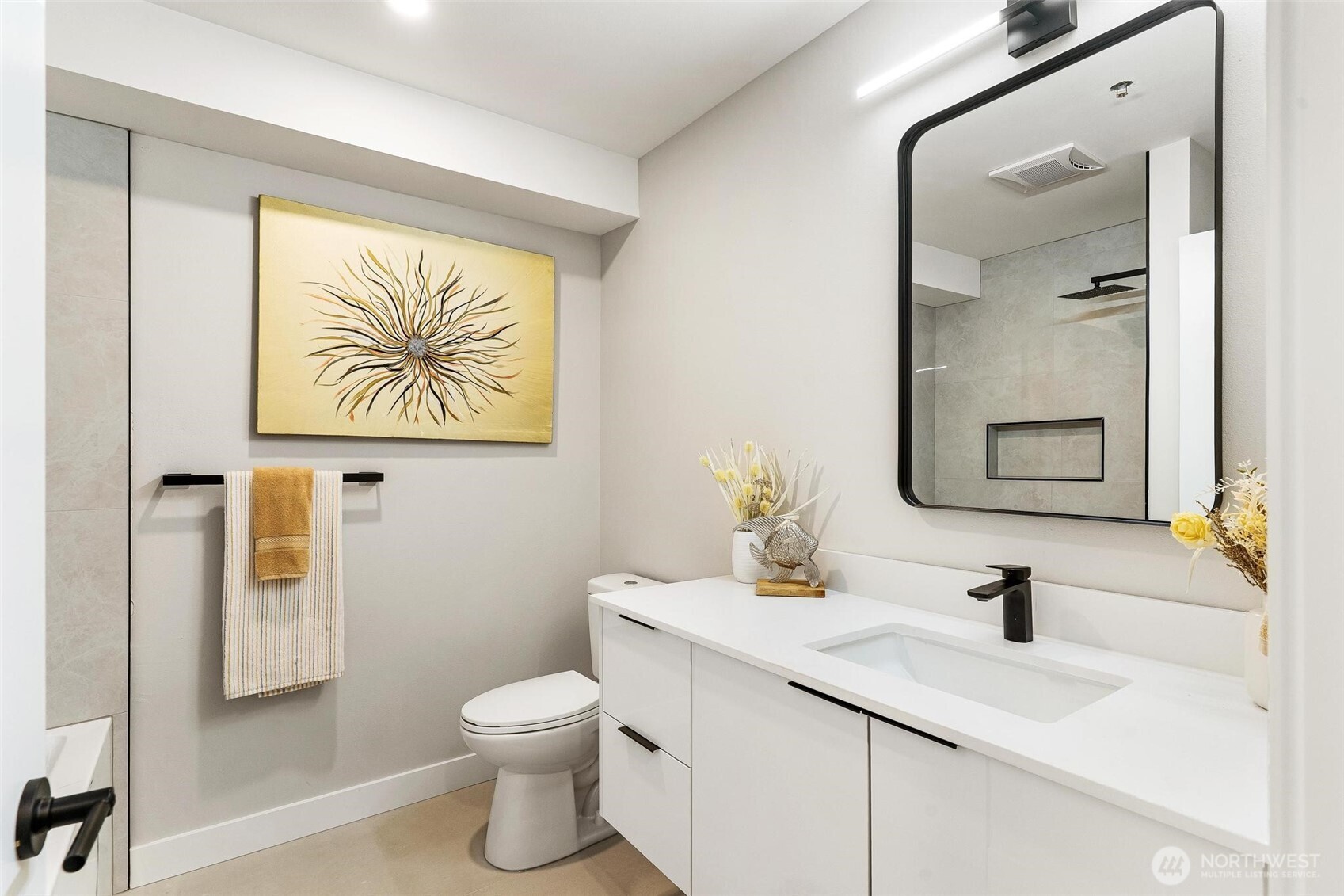 7146 47th Avenue Southwest Seattle, WA 98136 - Photo 21 of 34 a bathroom with a toilet a sink and mirror