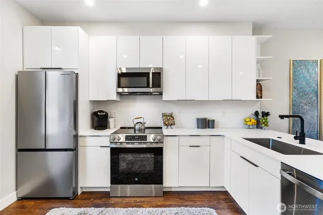 a kitchen with stainless steel appliances a refrigerator stove microwave and sink