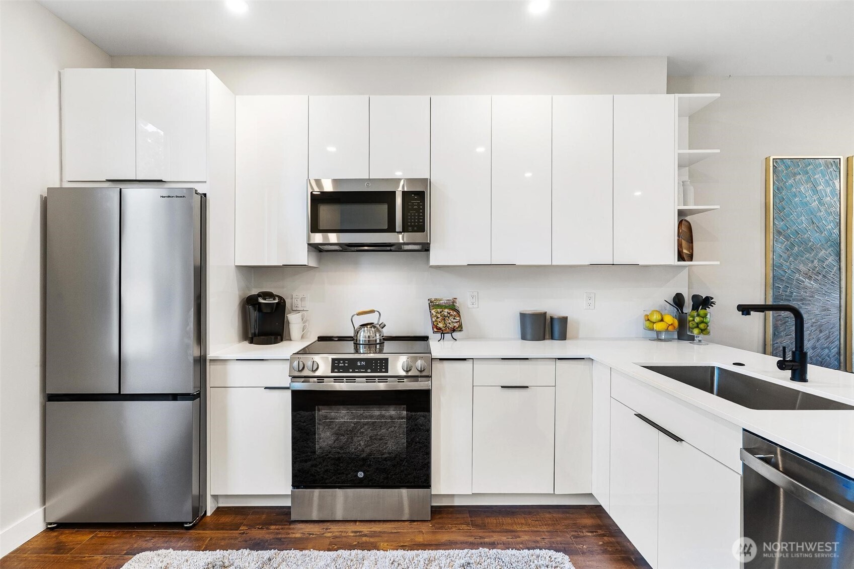 7146 47th Avenue Southwest Seattle, WA 98136 - Photo 6 of 34 a kitchen with stainless steel appliances a refrigerator stove microwave and sink