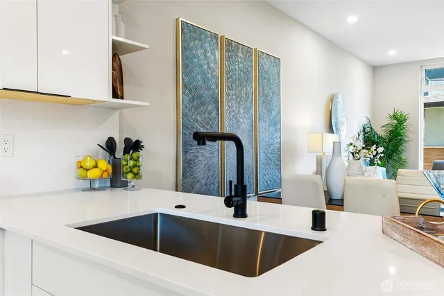 a kitchen with a sink a stove and chairs