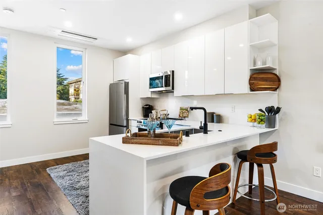 a dining room with furniture and a kitchen view