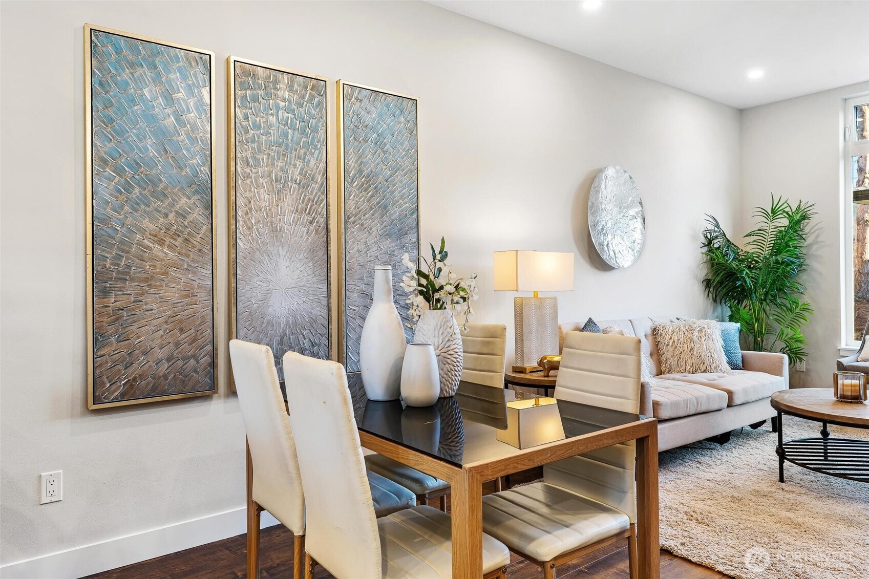 7146 47th Avenue Southwest Seattle, WA 98136 - Photo 10 of 34 a living room with couches a coffee table and a potted plant with wooden floor