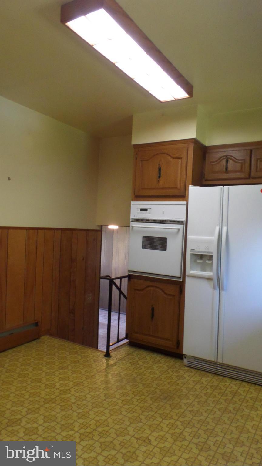 1413 Mt Airy Road Baltimore, MD 21237 - Photo 14 of 28 a kitchen with stainless steel appliances a refrigerator and a stove