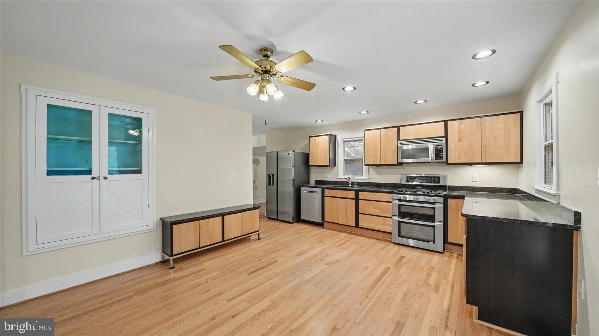 4037 Grande View Drive Pylesville, MD 21132 - Photo 17 of 74 a large kitchen with stainless steel appliances granite countertop a stove and a wooden floors