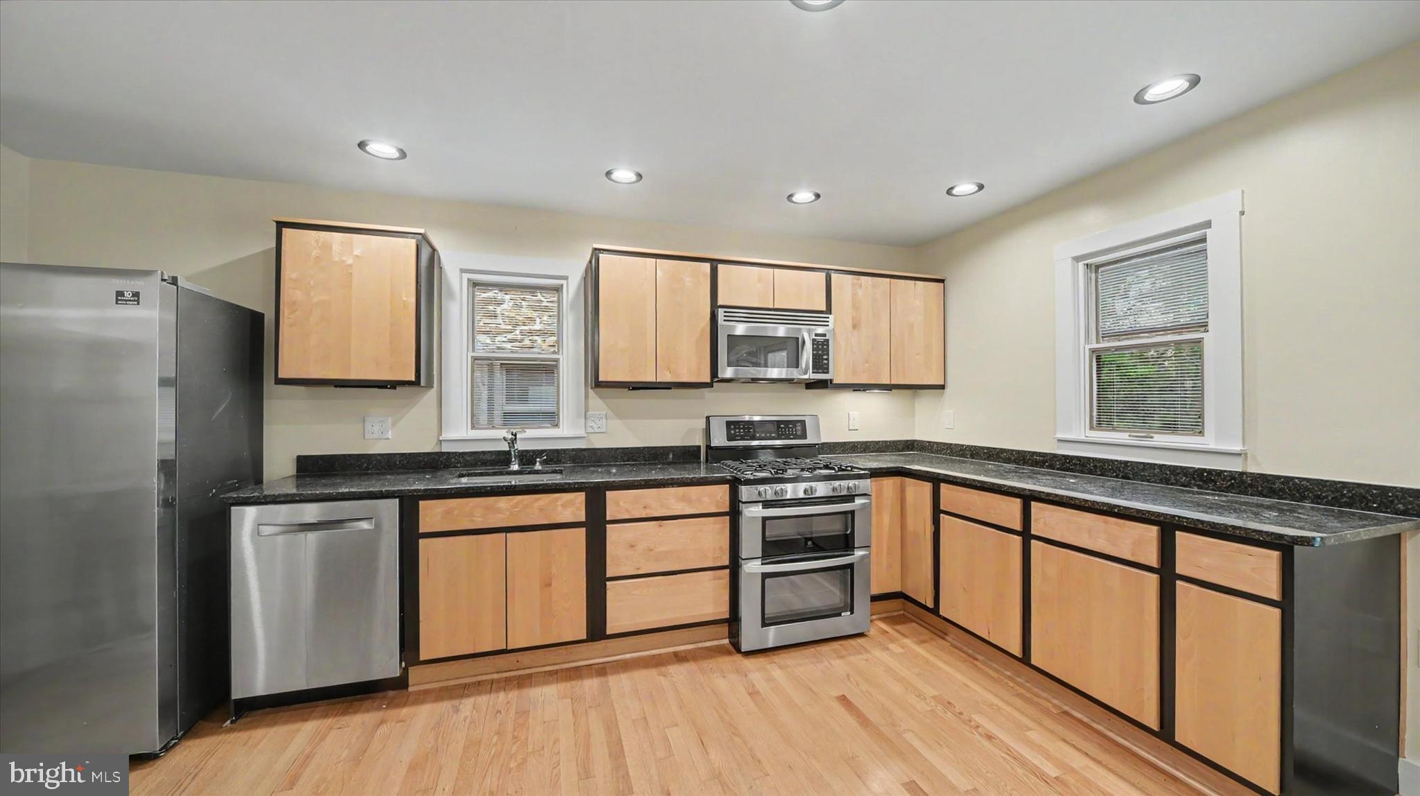 4037 Grande View Drive Pylesville, MD 21132 - Photo 18 of 74 a kitchen with stainless steel appliances granite countertop a stove a sink dishwasher and a refrigerator