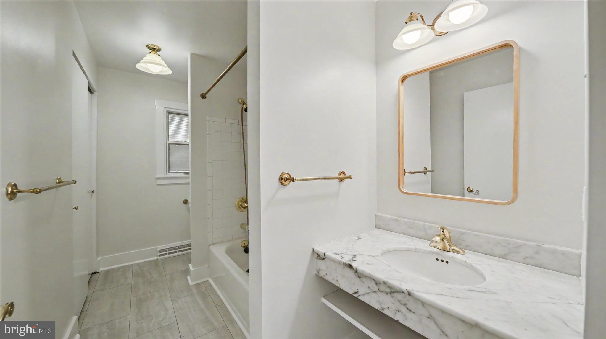 4037 Grande View Drive Pylesville, MD 21132 - Photo 22 of 74 a bathroom with a granite countertop sink a mirror and a shower