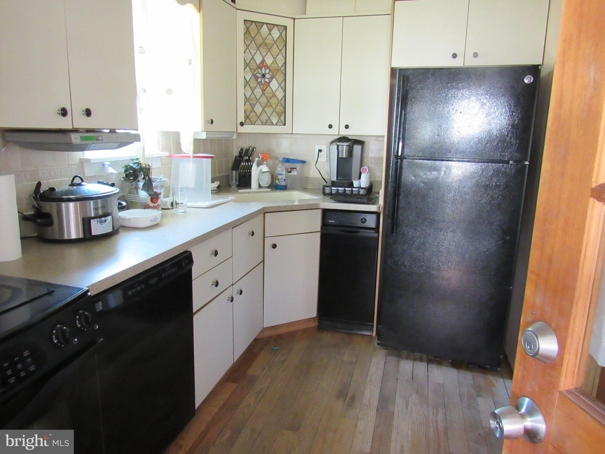 6301 Fieldvale Road Baltimore, MD 21237 - Photo 20 of 28 a kitchen with a refrigerator sink and cabinets