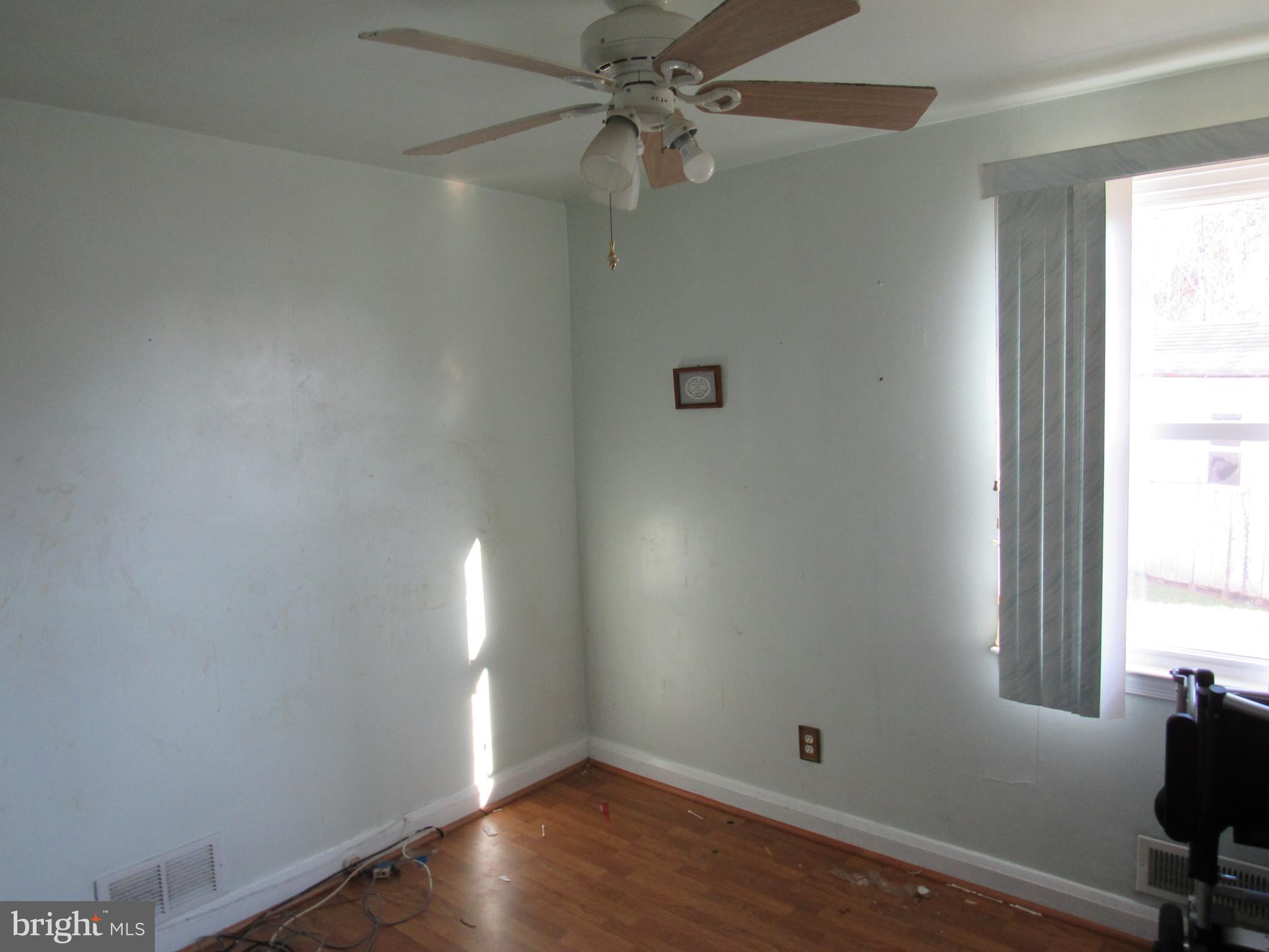 6301 Fieldvale Road Baltimore, MD 21237 - Photo 22 of 28 an empty room with a window and wooden floor