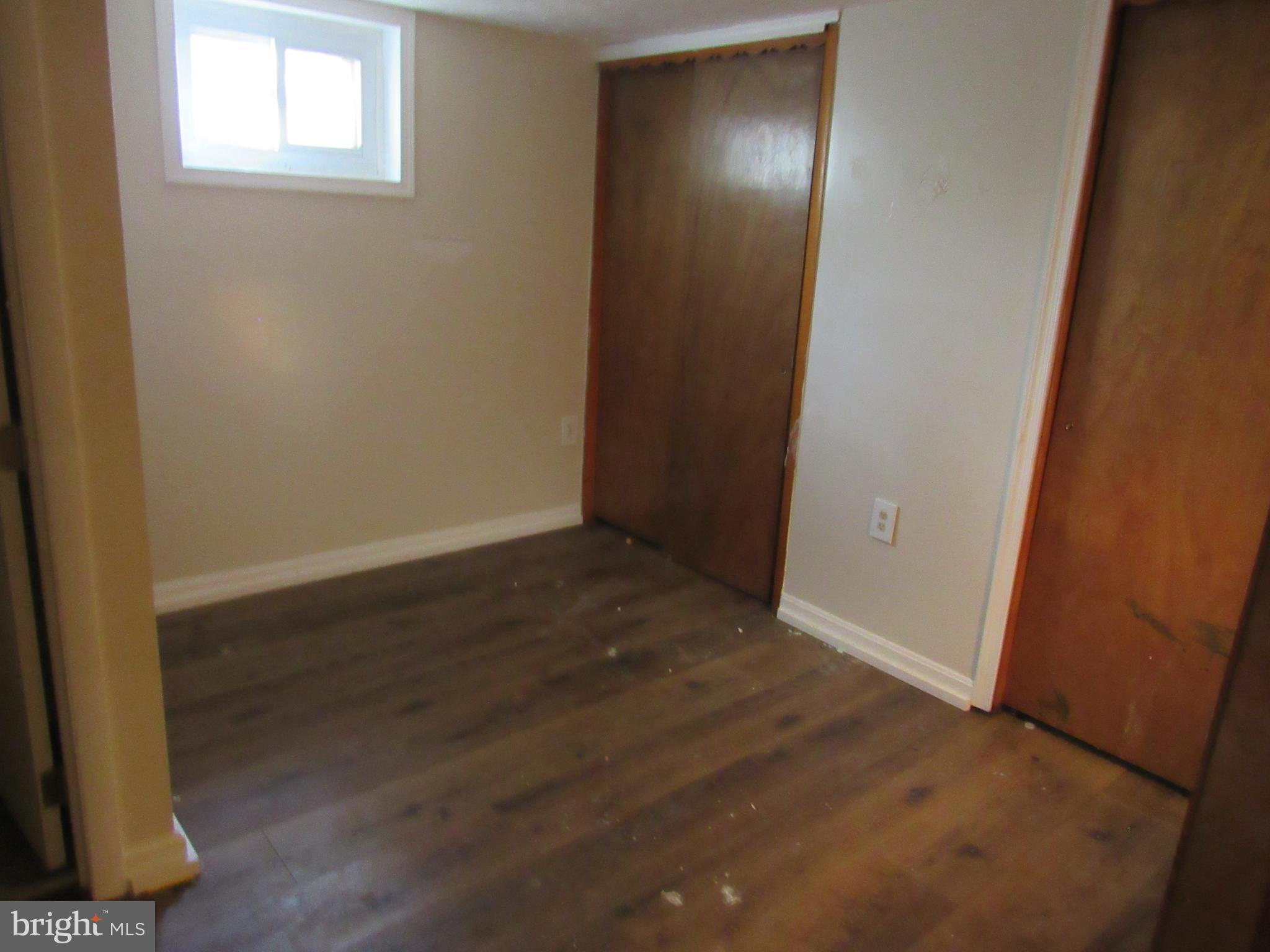 6301 Fieldvale Road Baltimore, MD 21237 - Photo 25 of 28 an empty room with wooden floor and windows