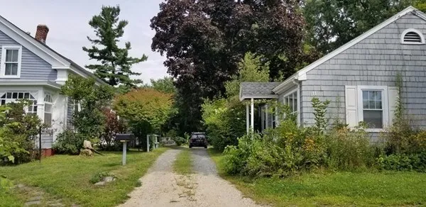 a view of a house with backyard and sitting area