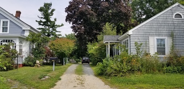 a view of a house with backyard and sitting area